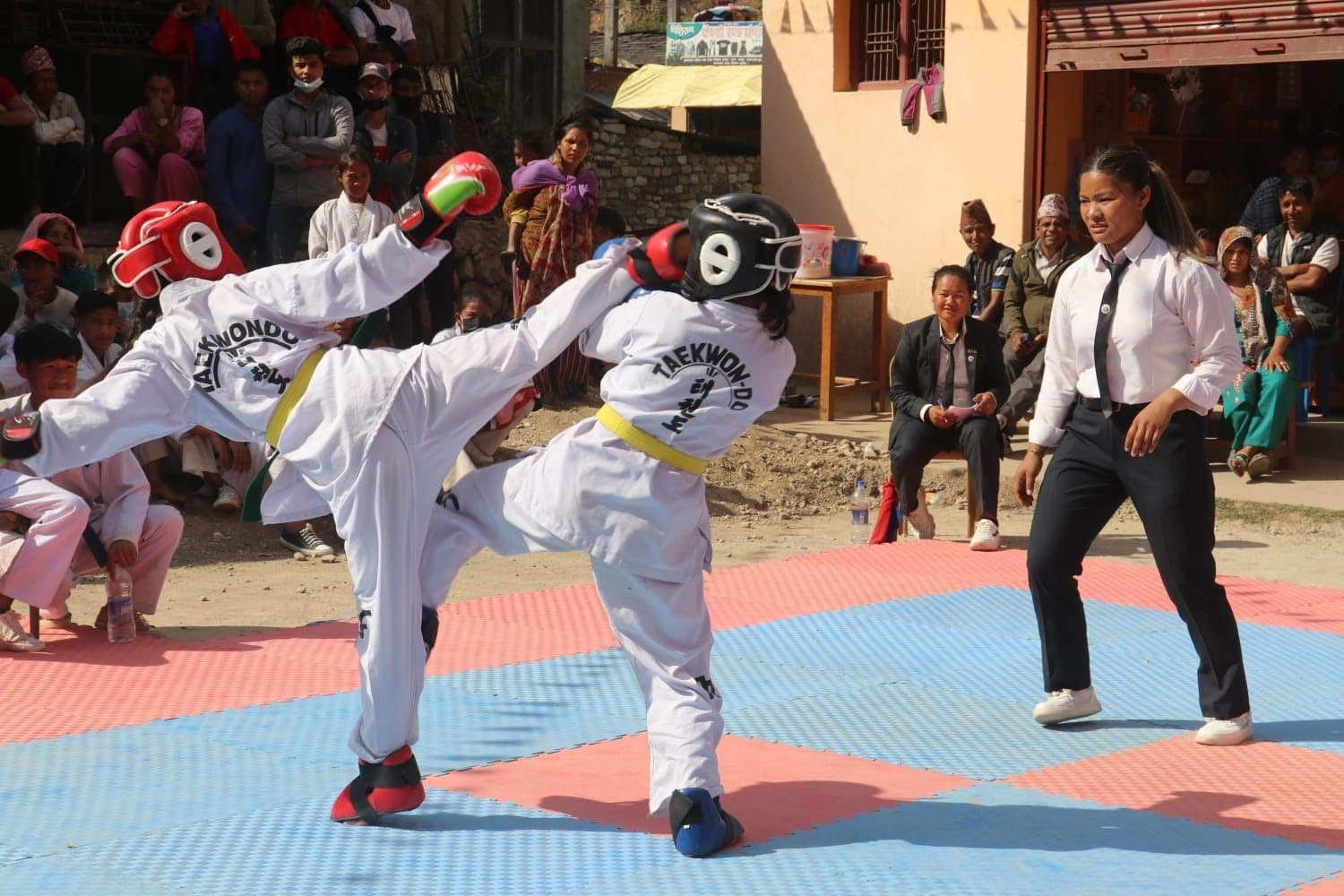 A competitor delivers a high side kick during a sparring bout