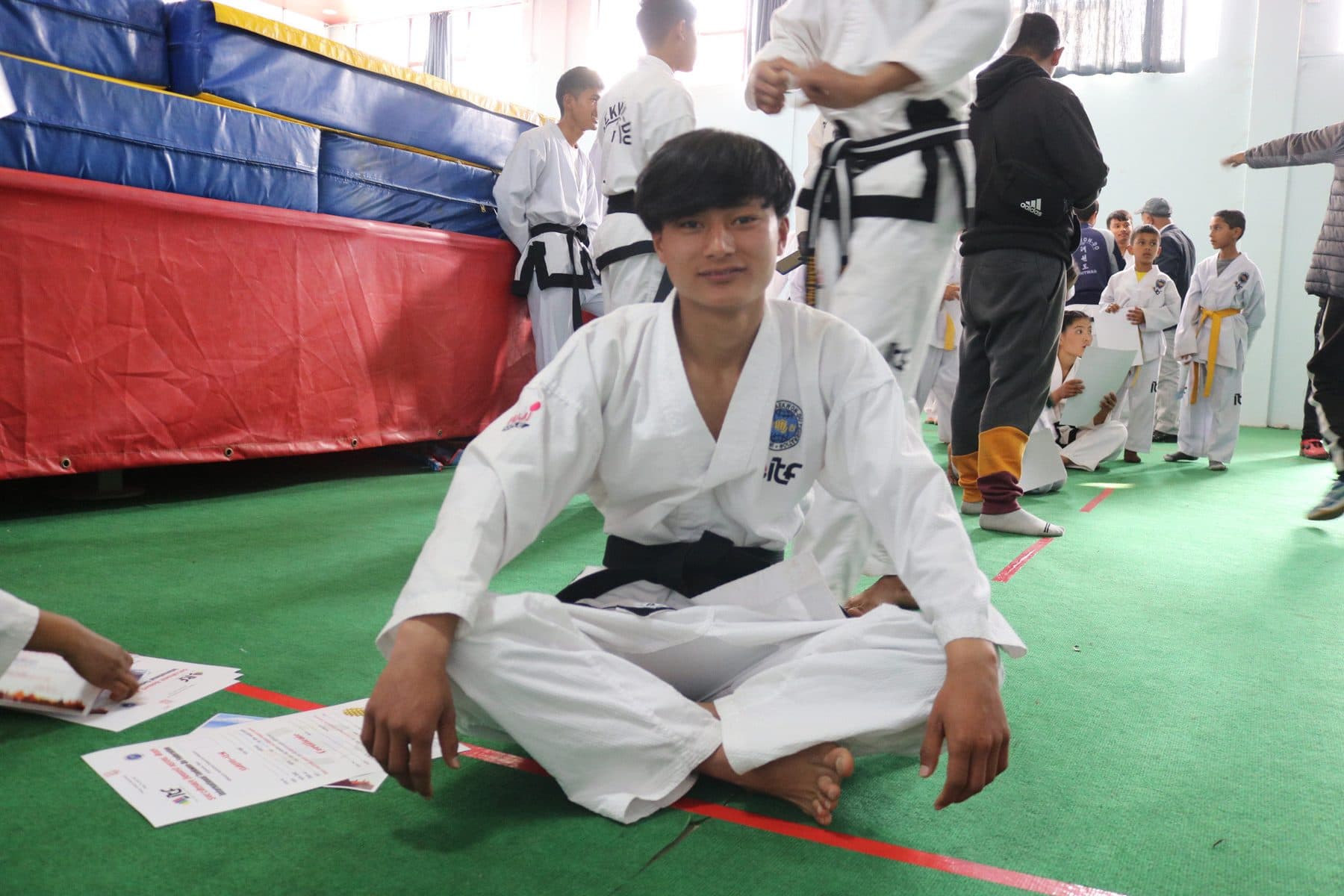 A candidate completing the written paper at a Dan grading